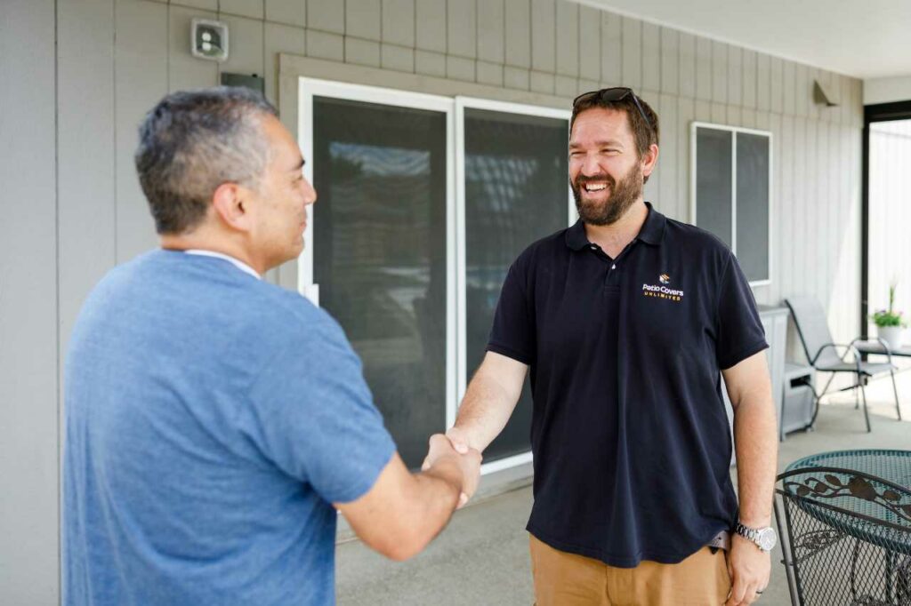 Patio Covers Unlimited shaking hands with client