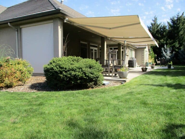 retractable awnings in a beautiful garden Patio Covers Unlimited