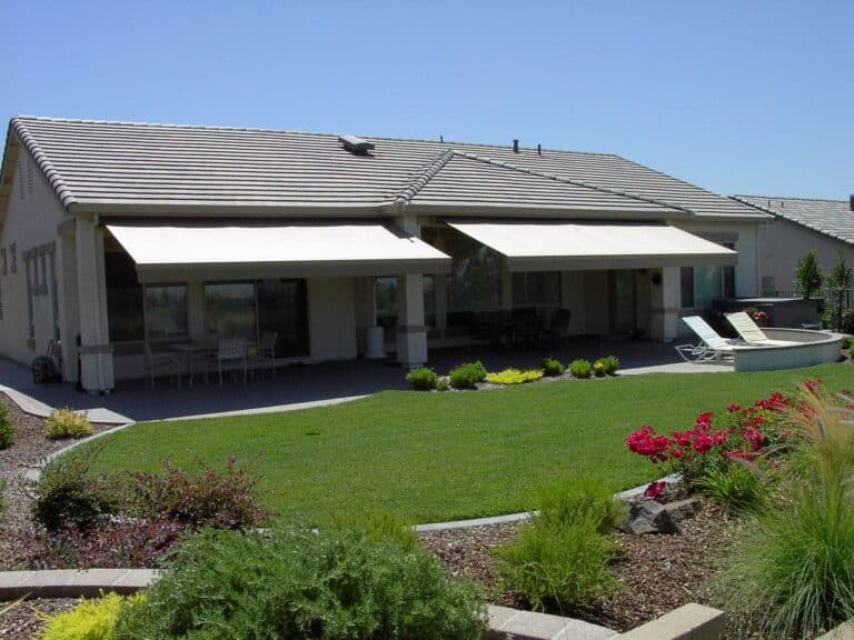 a beautiful lawn with retractable awnings Patio Covers Unlimited